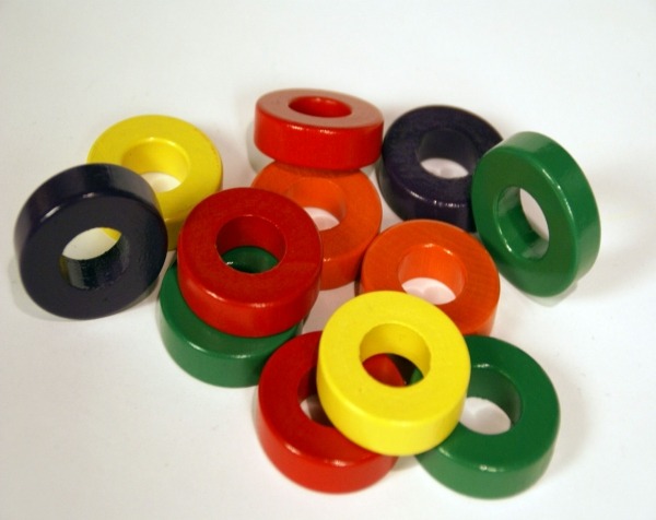 Assorted painted wooden rings in various colors, available in bulk for manufacturers and high-volume production.